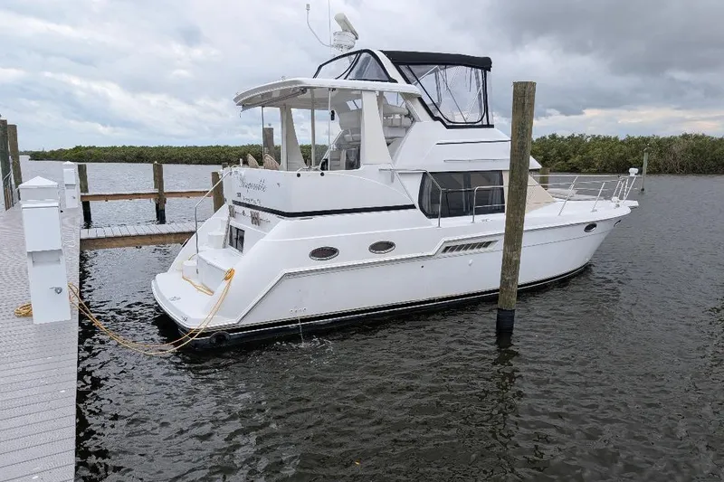 Slide: The Image of 2003 Carver 356 Motor Yacht docked on a cloudy day. - 3