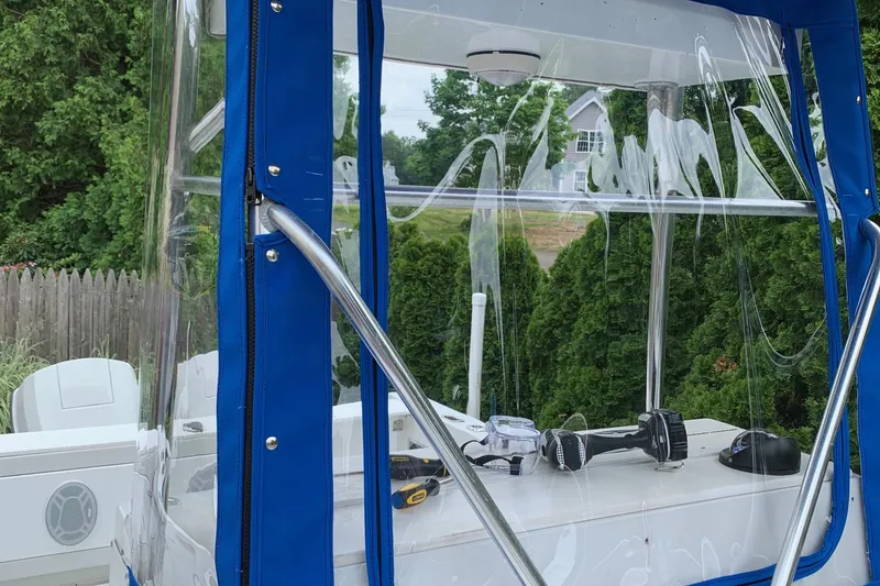 Slide: The Image of 1991 Four Winns 217 Quest boat with blue canopy and clear vinyl windows. - 11