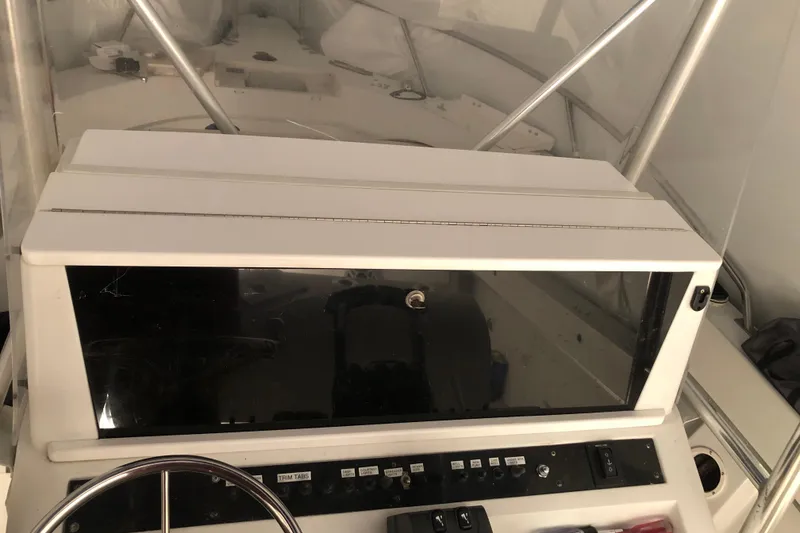 Slide: The Image of 1991 Four Winns 217 Quest boat dashboard with steering wheel and control panel. - 17