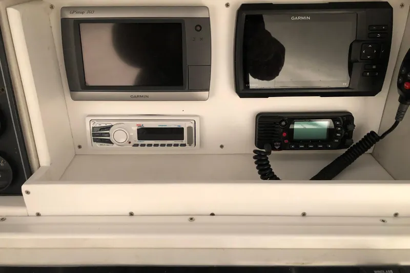 Slide: The Image of 1991 Four Winns 217 Quest boat dashboard with Garmin GPS and radio equipment. - 19