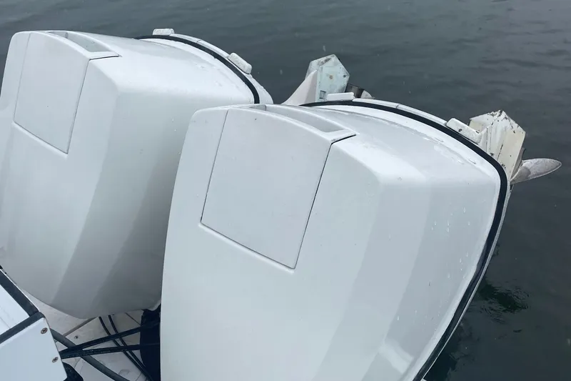 Slide: The Image of Twin outboard motors on a 1991 Four Winns 217 Quest boat. - 5