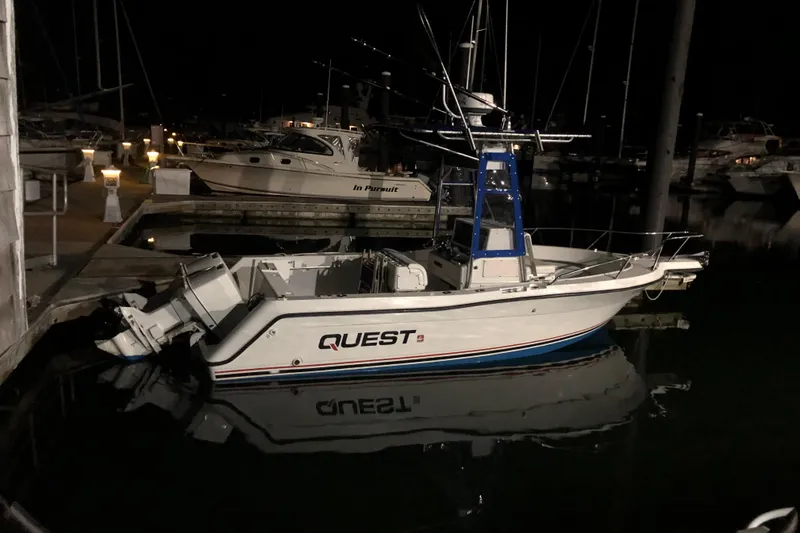 Slide: The Image of 1991 Four Winns 217 Quest boat docked at night, reflecting on calm water. - 9