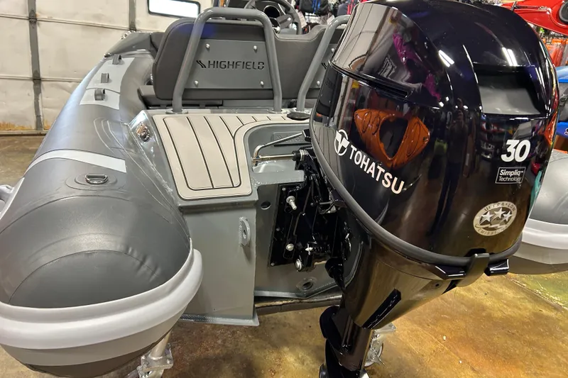 Slide: The Image of 2026 Highfield Sport 330 boat with Tohatsu 30 outboard motor in showroom. - 4