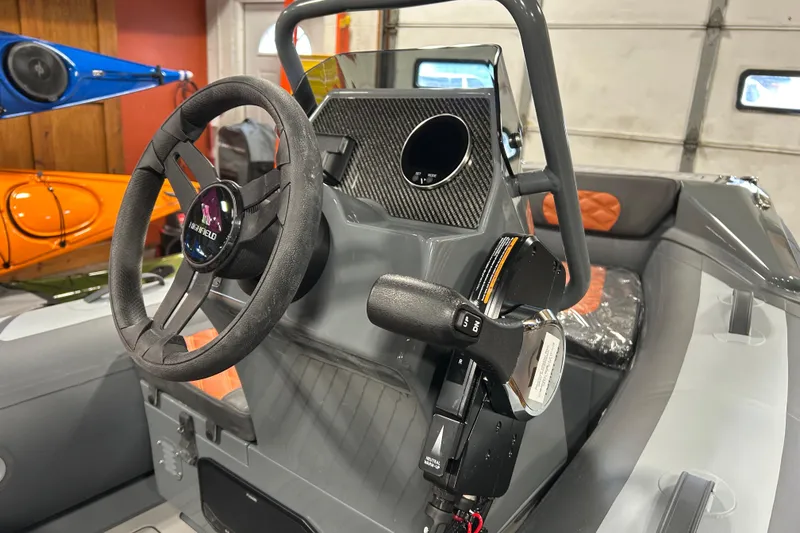 Slide: The Image of 2026 Highfield Sport 330 boat interior with steering wheel and control panel. - 7