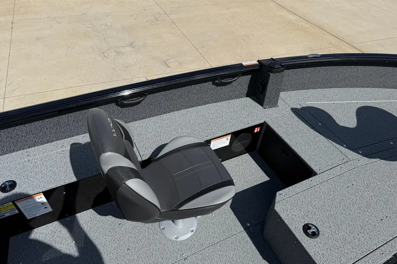 Slide: The Image of 2026 Lund 1800 Explorer Tiller boat interior with a single seat and gray flooring. - 14