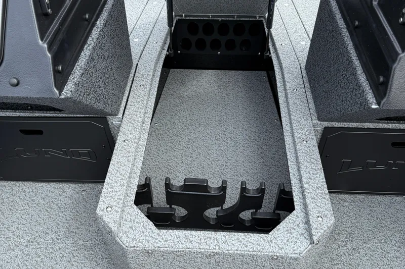 Slide: The Image of 2026 Lund 1800 Explorer Sport boat interior with rod storage compartments. - 12