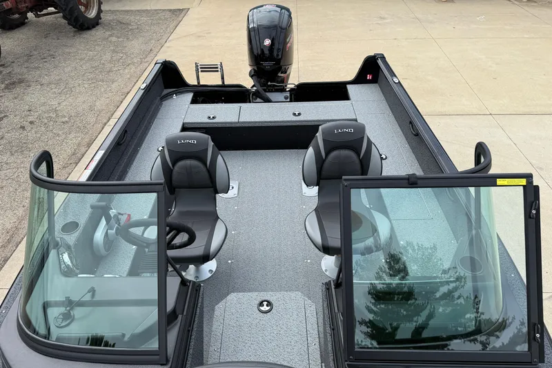 Slide: The Image of 2026 Lund 1800 Explorer Sport boat interior with dual seats and windshield. - 13