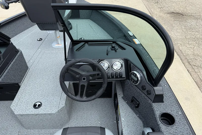 Slide: The Image of 2026 Lund 1800 Explorer Sport boat dashboard with steering wheel and gauges. - 16