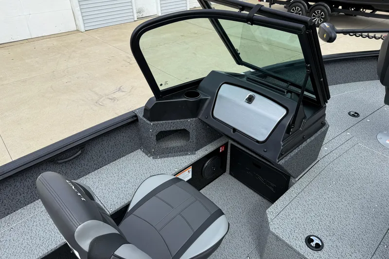 Slide: The Image of 2026 Lund 1800 Explorer Sport boat interior with seating and console. - 18