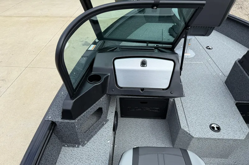 Slide: The Image of 2026 Lund 1800 Explorer Sport boat interior with windshield and storage compartments. - 19