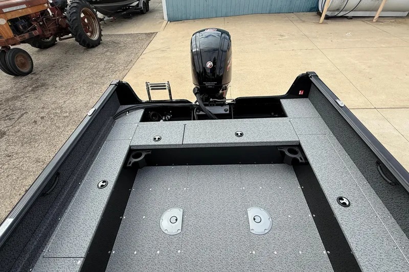 Slide: The Image of 2026 Lund 1800 Explorer Sport boat interior with motor, showcasing spacious deck design. - 21