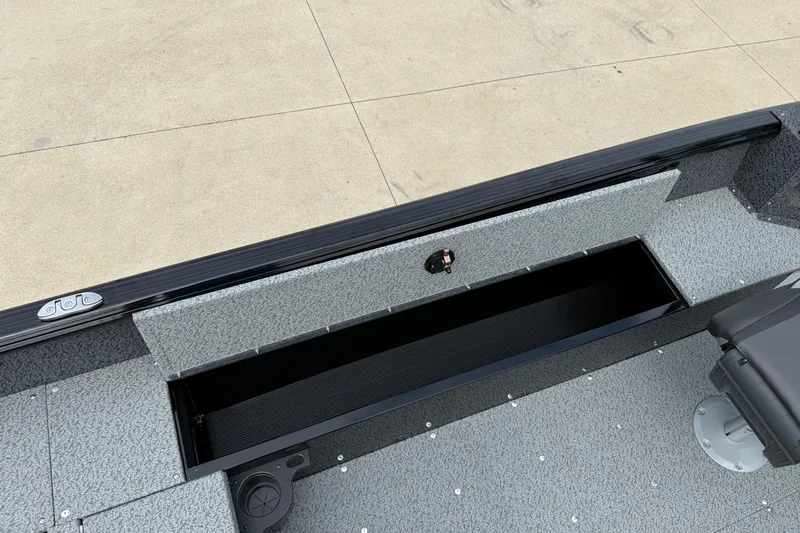 Slide: The Image of 2026 Lund 1800 Explorer Sport boat interior with open storage compartment. - 22