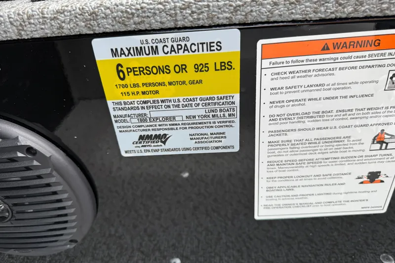 Slide: The Image of 2026 Lund 1800 Explorer Sport boat capacity label, 6 persons or 925 lbs, safety warnings visible. - 26