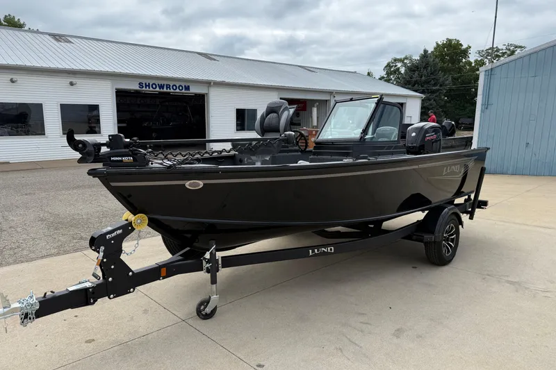 Slide: The Image of 2026 Lund 1800 Explorer Sport boat on trailer outside showroom. - 3