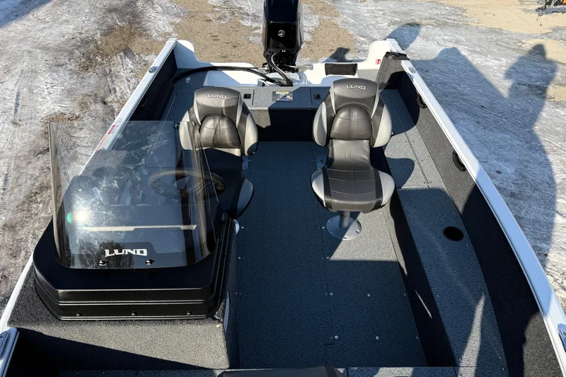 Slide: The Image of 2026 Lund 1650 Rebel XL SS boat interior with two seats and steering console. - 12