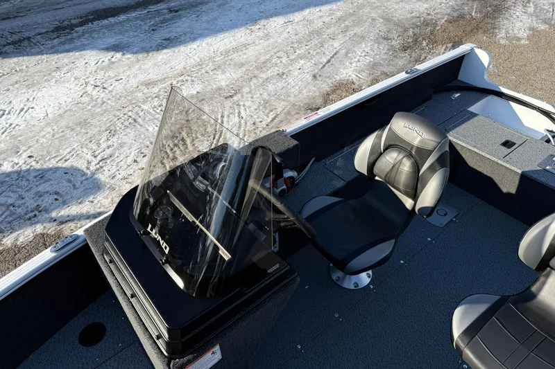 Slide: The Image of 2026 Lund 1650 Rebel XL SS boat interior with steering console and seating. - 13