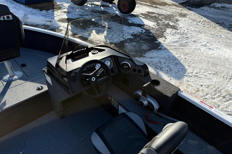 Slide: The Image of 2026 Lund 1650 Rebel XL SS boat interior with steering console and seating. - 14