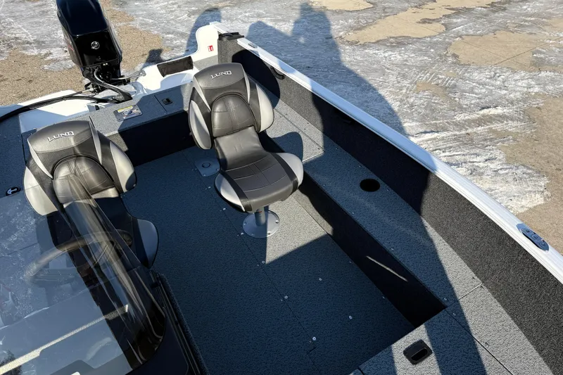 Slide: The Image of 2026 Lund 1650 Rebel XL SS boat interior with two seats and steering console. - 16