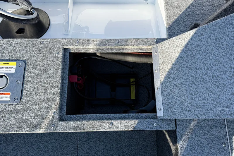 Slide: The Image of Open storage compartment on 2026 Lund 1650 Rebel XL SS boat, showing interior details. - 22