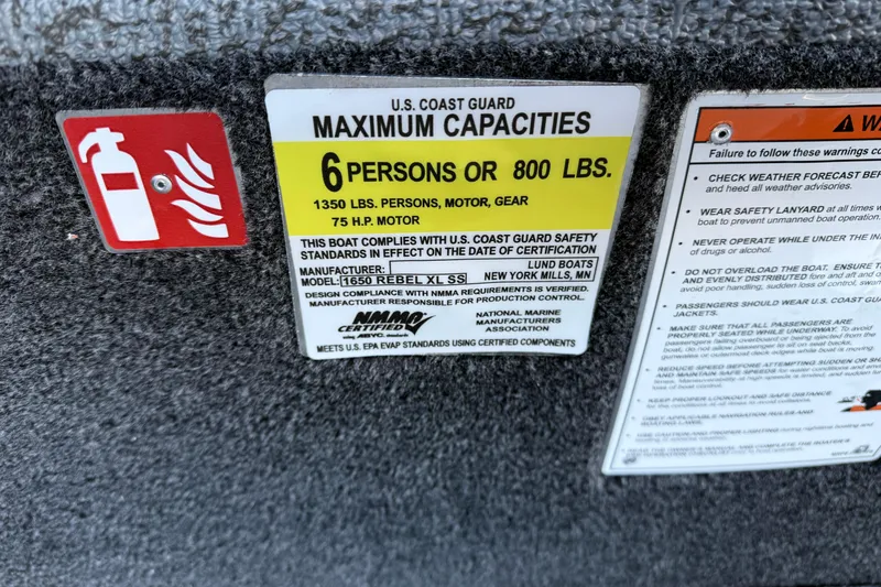 Slide: The Image of 2026 Lund 1650 Rebel XL SS boat capacity label, 6 persons or 800 lbs, safety instructions. - 24