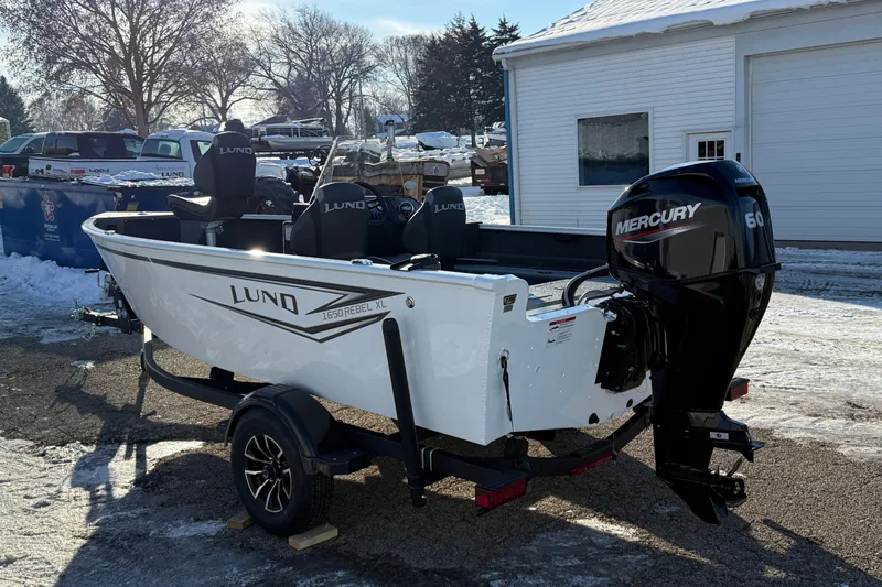 Slide: The Image of 2026 Lund 1650 Rebel XL SS boat with Mercury 60 engine, parked on snowy ground. - 5