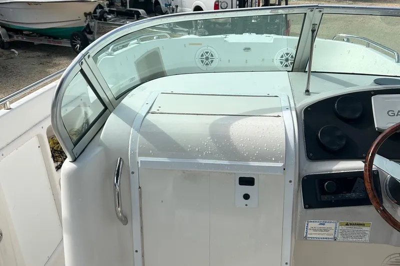 Slide: The Image of 2004 Hurricane SD 260 boat dashboard with steering wheel and windshield. - 5