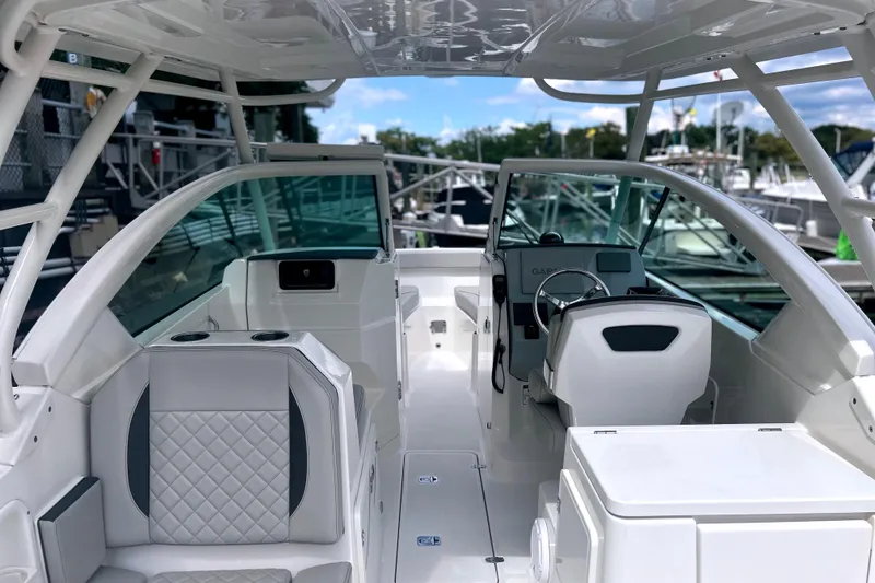 Slide: The Image of 2023 Pursuit DC 266 Dual Console boat interior with modern seating and steering wheel. - 11