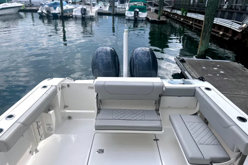 Slide: The Image of 2023 Pursuit DC 266 Dual Console boat interior at marina dock. - 13