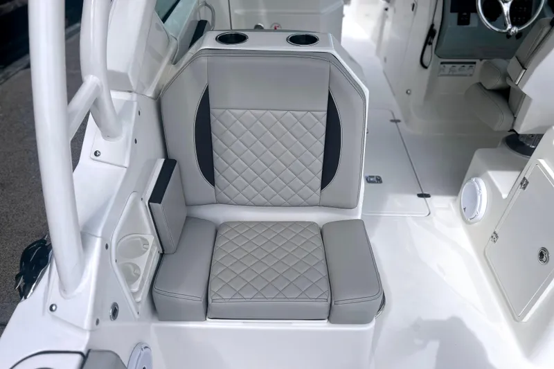 Slide: The Image of 2023 Pursuit DC 266 Dual Console boat seat with quilted upholstery and cup holders. - 14