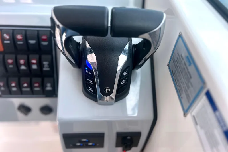 Slide: The Image of 2023 Pursuit DC 266 Dual Console boat throttle controls and dashboard. - 22