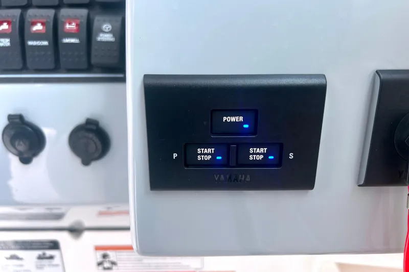 Slide: The Image of Control panel of 2023 Pursuit DC 266 Dual Console boat with Yamaha start-stop buttons. - 23