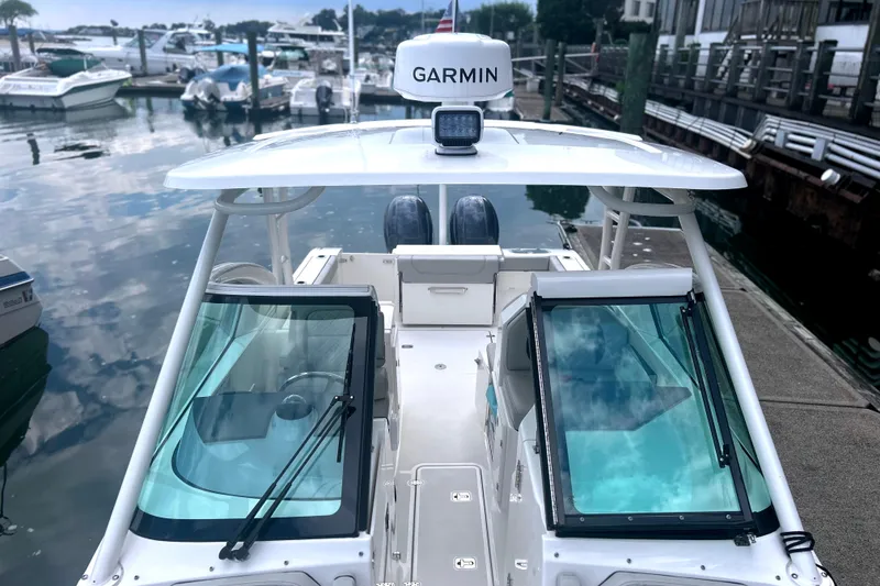 Slide: The Image of 2023 Pursuit DC 266 Dual Console boat docked with Garmin equipment. - 26