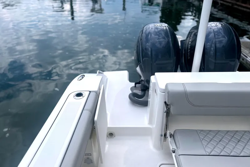 Slide: The Image of 2023 Pursuit DC 266 Dual Console boat with twin engines at dock. - 31