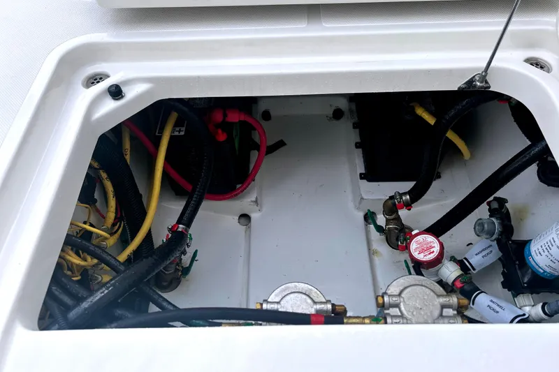 Slide: The Image of 2023 Pursuit DC 266 Dual Console engine compartment with wiring and components. - 32