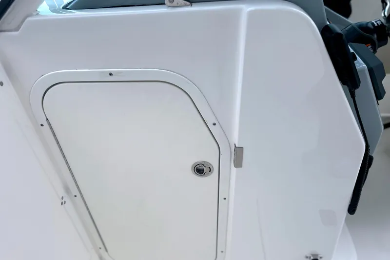 Slide: The Image of 2023 Pursuit DC 266 Dual Console boat storage compartment door. - 37