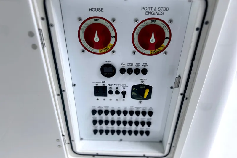 Slide: The Image of Control panel of 2023 Pursuit DC 266 Dual Console boat, featuring switches and dials. - 38