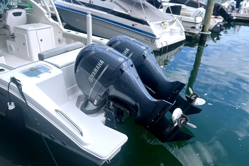 Slide: The Image of 2023 Pursuit DC 266 Dual Console with twin Yamaha outboard motors docked. - 8