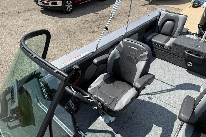 Slide: The Image of 2026 Lund 1975 Tyee boat interior with comfortable seating and steering console. - 12