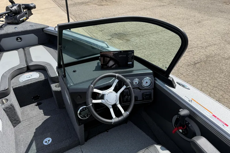 Slide: The Image of Interior of 2026 Lund 1975 Tyee boat, featuring steering wheel and dashboard controls. - 14