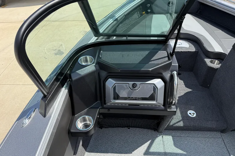 Slide: The Image of 2026 Lund 1975 Tyee boat interior with open windshield and cup holders. - 17