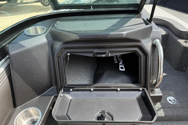 Slide: The Image of 2026 Lund 1975 Tyee boat interior with open storage compartment and cup holder. - 19
