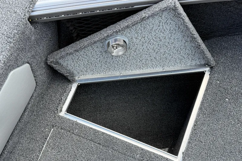 Slide: The Image of Open storage compartment in 2026 Lund 1975 Tyee boat, featuring carpeted interior and light. - 23