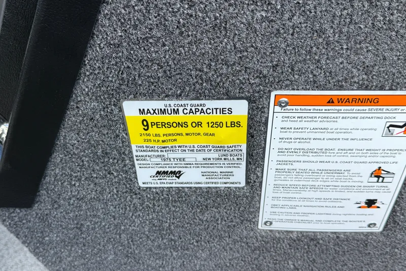 Slide: The Image of Capacity warning label on 2026 Lund 1975 Tyee boat, indicating 9-person or 1250 lbs limit. - 25