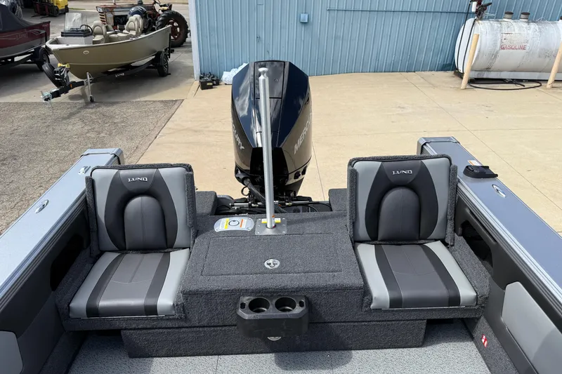 Slide: The Image of 2026 Lund 1975 Tyee boat interior with dual seats and Mercury outboard motor. - 29