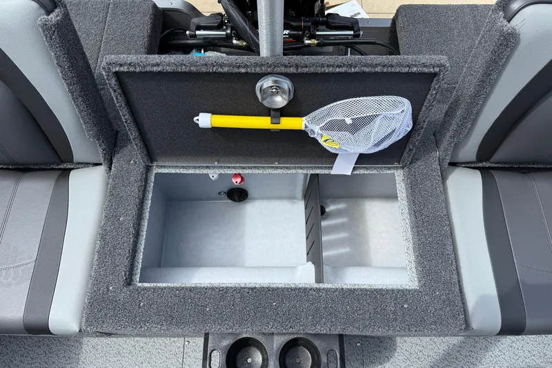 Slide: The Image of Interior of 2026 Lund 1975 Tyee boat showing storage compartment with net and tool. - 30