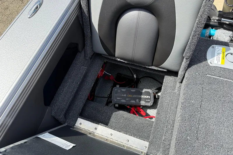 Slide: The Image of Interior of 2026 Lund 1975 Tyee boat showing NOCO Boost Pro battery charger. - 31