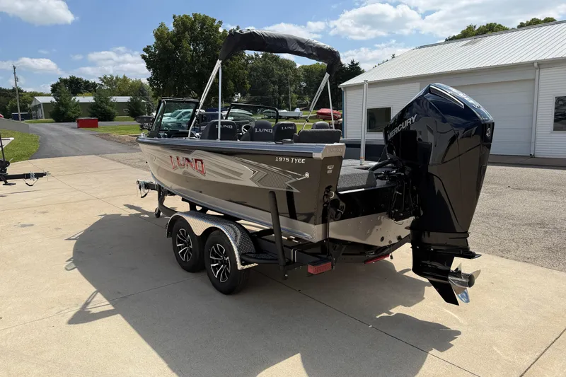 Slide: The Image of 2026 Lund 1975 Tyee boat on trailer, parked outdoors under a sunny sky. - 5