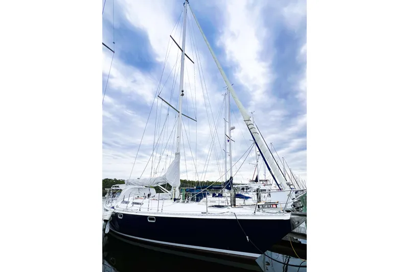 The Image of 1984 Trintella 42 sailboat docked under a cloudy sky. - 0