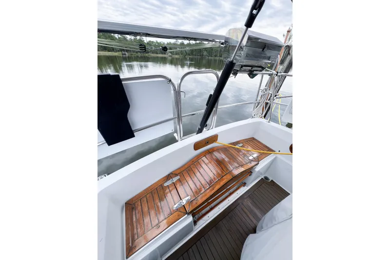 Slide: The Image of Cockpit of 1984 Trintella 42 sailboat with wooden seating and scenic water view. - 10