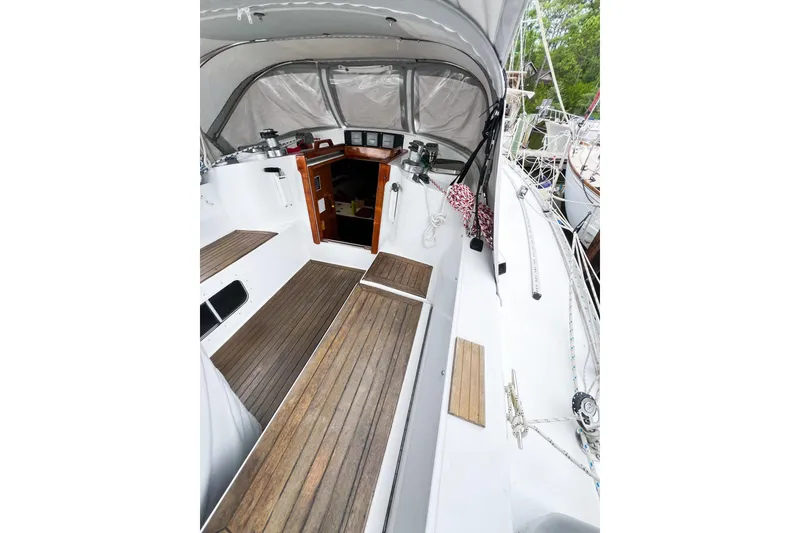 Slide: The Image of 1984 Trintella 42 sailboat cockpit with wooden flooring and canopy. - 13